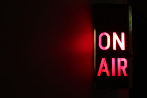 Red-and-black-image-of-on-air-sign