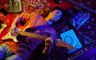 Guitarist-lying-on-carpet-singing