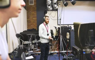 Man-in-recording-studio-who-will-need-music-distribution-services